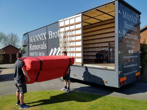 Loading sofa onto removals truck