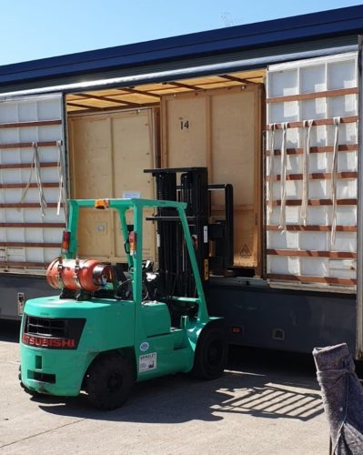 Loading storage containers into lorry